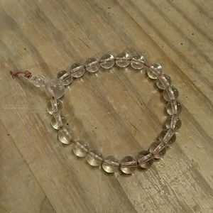 Vintage power beads.  Clear, beaded bracelet on red cord.